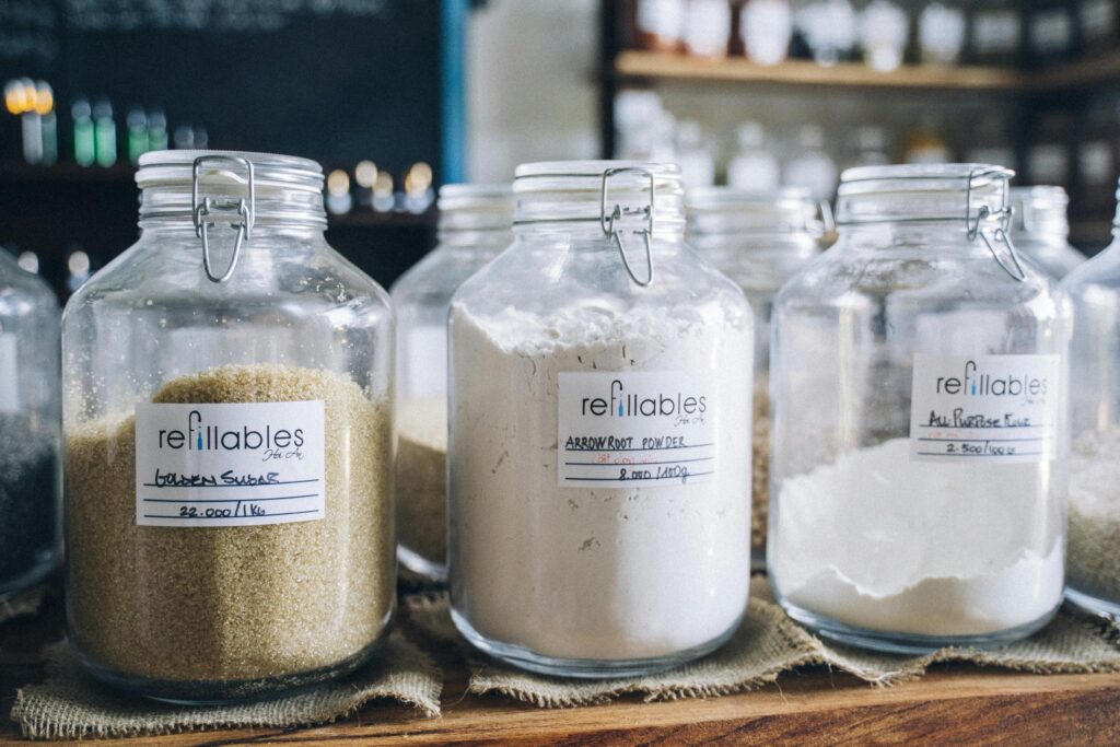 A variety of bulk organic ingredients in refillable glass jars at an eco-friendly store.